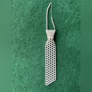 Vintage necktie with “pearls” / white beads with a hook in the back.